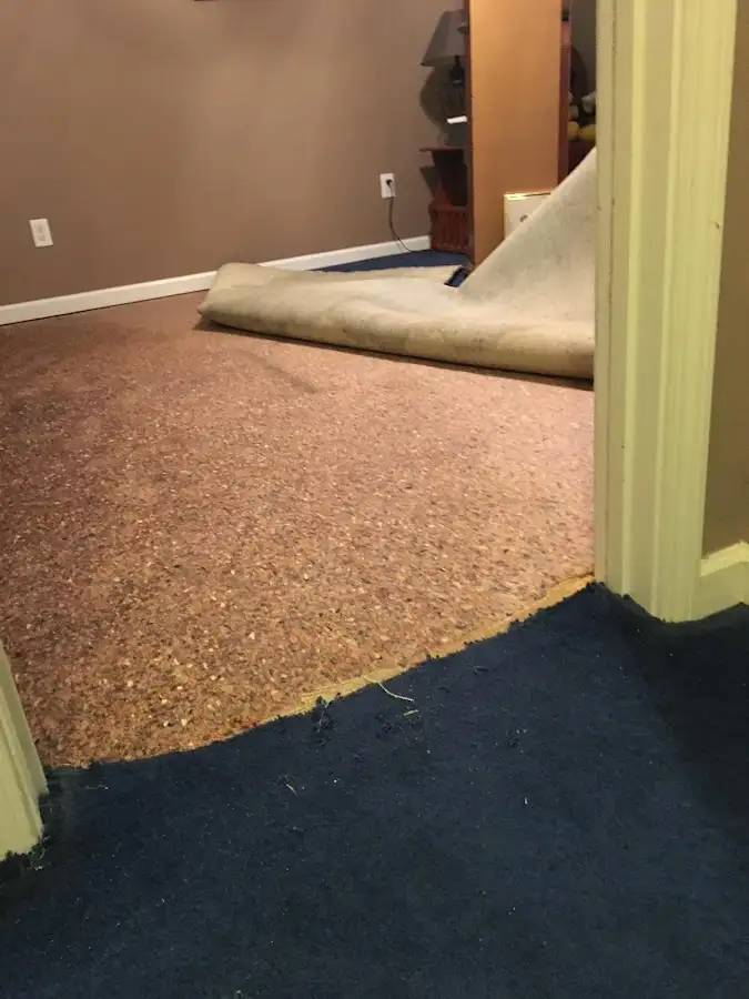 Carpet pad removal revealing water damage during Drying & Dehumidification in Ruidoso